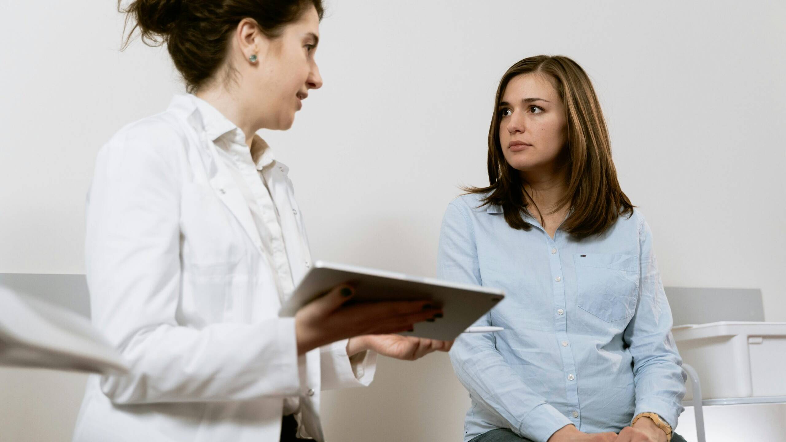 Doctor reviews pregnancy options with patient.